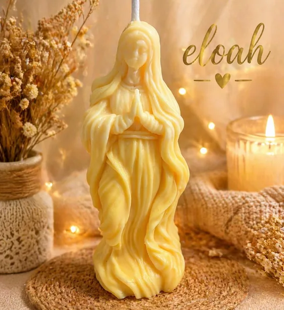 Vela alta de la Virgen en tono amarillo junto a velas encendidas